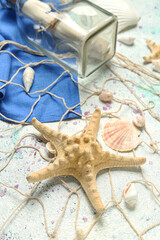 Starfish with sea shells and net on grunge background, closeup