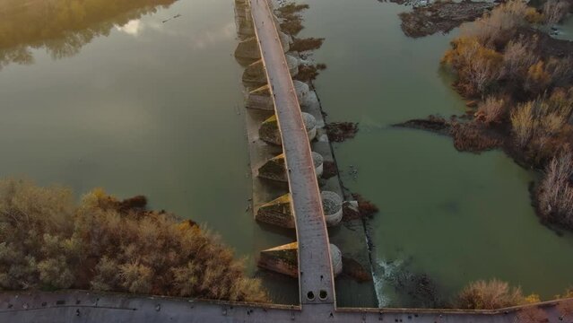 Establishing Aerial View Shot of The Roman bridge of Cordoba, a bridge in the Historic centre of Cordoba, Andalusia, southern Spain