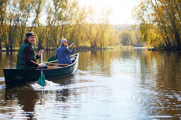 Were always up for a new adventure. Portrait of a young couple going for a canoe ride on the lake.