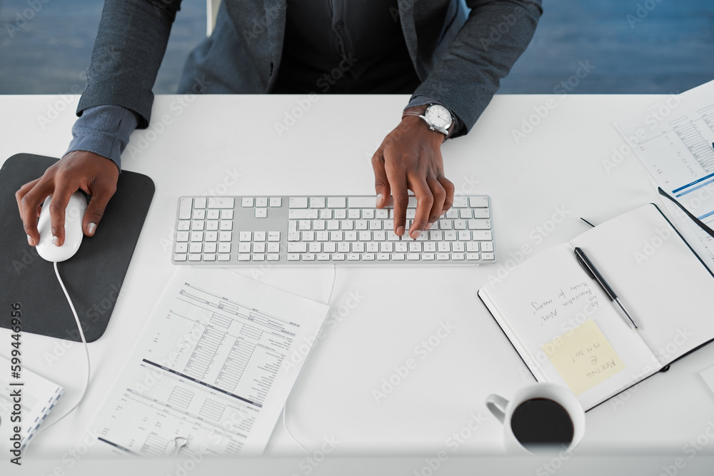 Poster productivity is just a click away. cropped high angle shot of a young businessman using a computer a