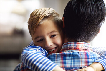 Obraz premium Youre simply the bestest Dad. an adorable little boy hugging his father at home.