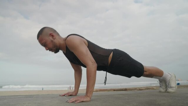 LGBT Queer Gay Man Male Warming Up Exercise on the Beach - Body Movement, Stretching, Jogging, Push Ups and Skipping
