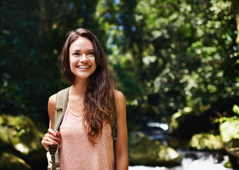 Not all who wander are lost. a beautiful young woman hiking through the forest.