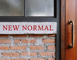 Brick wall with red text inscription NEW NORMAL, state to which economy or society settles following crisis which differs from prior situation, especially post pandemic