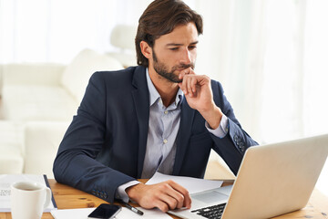 Hmmm, this is interesting...A handsome businessman working on his laptop.