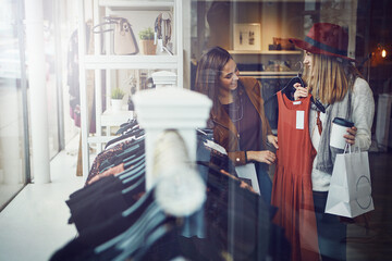Birds of a feather shop together. two best friends out shopping in a clothing store.