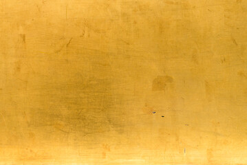 Fototapeta premium Artificial Gold background and texture on cement make from color paint for look like real gold. Gold foil leaf dirty abstract background texture distress scratch and gradients shadow in Gold glitter