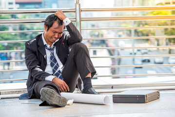 business man in suit frustrated he sad for lost work job sit on street upset fail unhappy after Fired from covid19. Many employee unemployed to reduce expenses salary income dismissal - obrazy, fototapety, plakaty
