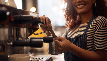 One cup of magic, coming right up. Closeup shot of a barista operating a coffee machine in a cafe.