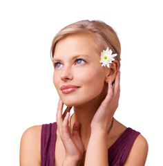 Fototapeta premium Soft as a petal. Studio shot of a beautiful young woman with a flower in her hair isolated on white.