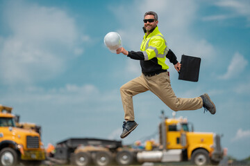 Fast building. Funny construction worker jumping. Excited jump of builders run in helmet. Worker in...
