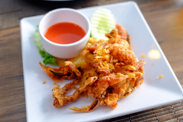 Deep-Fried Soft Shell Crab on Elegant Plate Served with hot sauce top view camera angle
