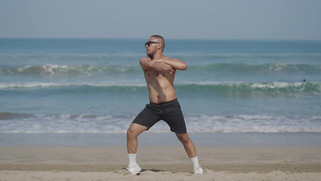 Handsome LGBT Queer Gay Man Male Dancer Dance on the Beach with Confidence Topless on a Blue Sunny Day