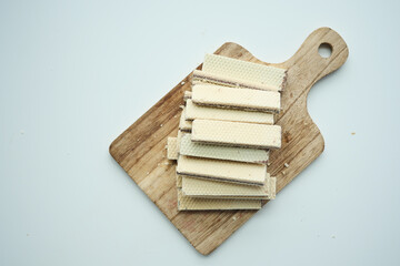  top view of wafer roll chocolate on wooden board on table 