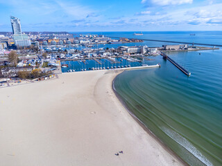 Aerial view landscape Poland Gdynia. City beach, view of marine and harbor. Empty beach, blue sky.