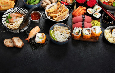 Traditional Japanese food dishes on black background, top view, copy space