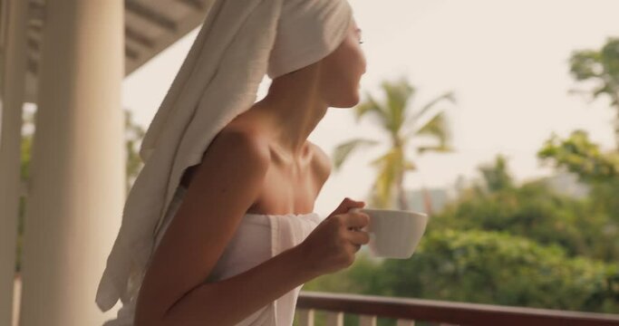 Woman With a Cup of Coffee After Shower on Open Resort Balcony Against