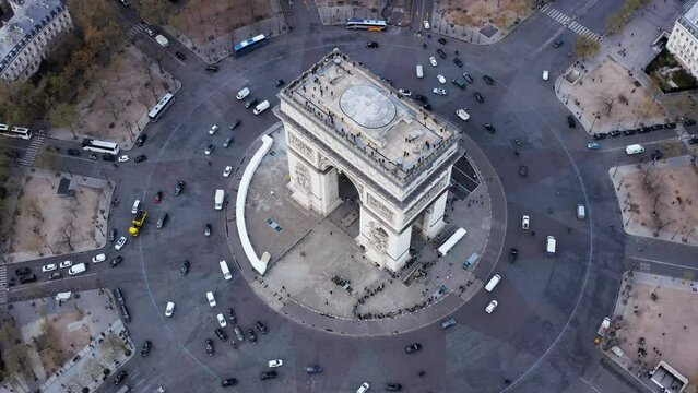 High angle aerial view of Arc de Triumph landmark in Paris.
Cars driving on famous roundabout 