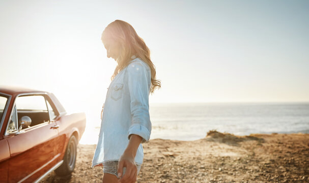 The great outdoors is the place to be. a beautiful young woman going on a road trip to the beach.