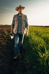 A Caucasian man walks across the farm
