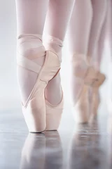 Fotobehang Dansschool Ballet, dance and shoes with the en pointe feet of a ballerina group in a studio for rehearsal or recital. Creative, stage and theatre production with a dancer closeup training for an artistic show