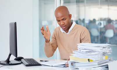Stress, documents and burnout with a business black man in an office, sitting at a desk while...