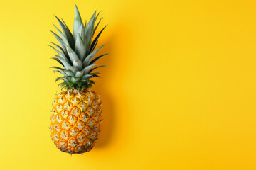 Pineapple on yellow background. Top View. Copy Space. Pattern for minimal style. Pop art design, creative concept	