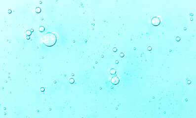 Cosmetic gel close-up with oxygen bubbles. Textured background with microbrushes in cosmetics. Moisturizing skin serum with vitamins and collagen.