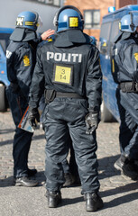 Safety, crowd control and protest with police officer in city for riot, protection or security. Brave, uniform and government with person in Denmark street for rally, human rights or activist