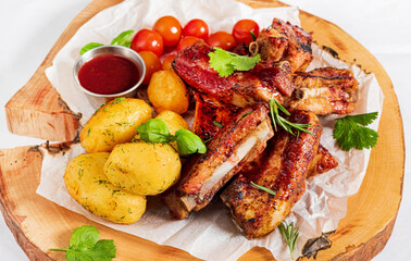 grilled ribs with potatoes and vegetables