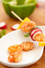 Food, nutrition and prawn on a plate in a restaurant for hospitality in a luxury fine dining establishment. Shrimp, skewer and meal on a kitchen counter ready for serving in a hotel for healthy lunch