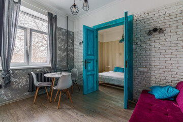 The interior of the apartment is in the old style, with high ceilings and an old wooden door of turquoise color