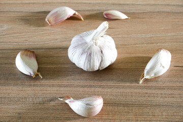 Garlic on a brown wooden surface