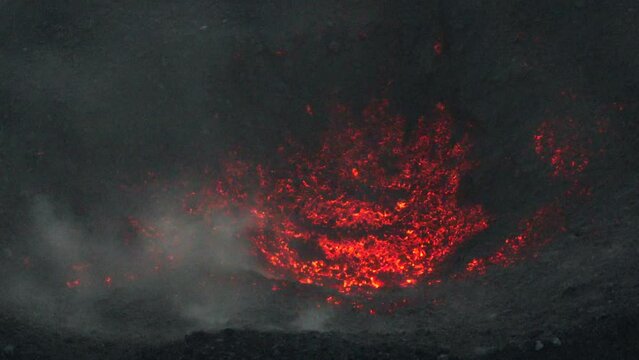Close up aerial footage of the magma and red hot rock in the crater of the volcano Fuego in Guatemala