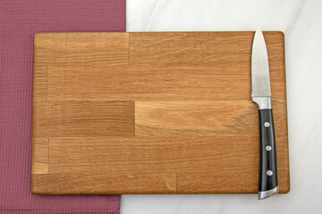 Wooden chopping board and a knife