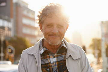Mature, portrait and man in the city with lens flare and happiness from retirement. Sunshine, urban...