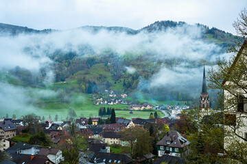 Clouds over the valley and village of Schönau im Schwarzwald in Black Forest area, Germany in the evening