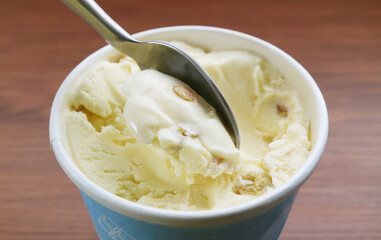 Closeup of spoon scooping delectable rum raisin ice cream
