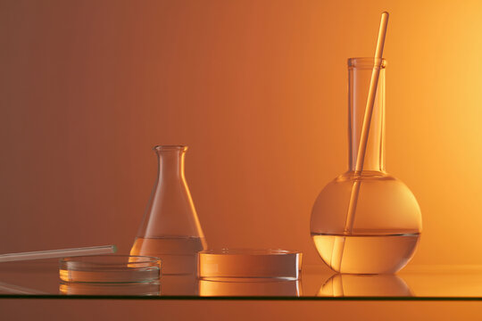 Laboratory glassware and glass rod decorated with a round transparent podium. Gradient orange background. Modern minimal showcase scene for cosmetic products promotion