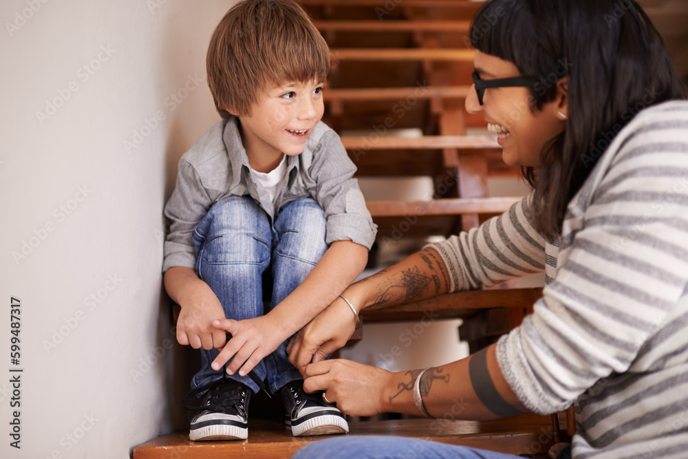 Wall mural Learning, tying and shoes with mother and kid for child development, bonding and helping. Happy, smile and support with woman and young boy on steps in family home for laces, care and happiness