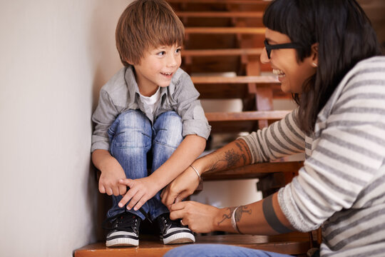 Learning, Tying And Shoes With Mother And Kid For Child Development, Bonding And Helping. Happy, Smile And Support With Woman And Young Boy On Steps In Family Home For Laces, Care And Happiness