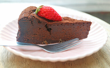 Closeup of Moist and Dense Texture of Flavorful Flourless Chocolate Cake Topped with Fresh Strawberry