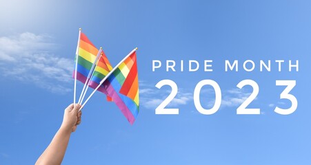'Pride Month 2023' on blurred rainbow flag raising background, concept for LGBT people celebrations in pride month, june, around the world.