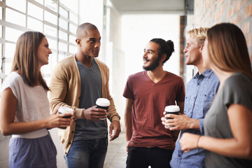 College, friends and talking with coffee in a hallway for diversity, happiness and a drink. Group of men and women students at campus or university for a chat or conversation about education career