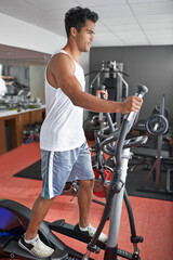 Fototapeta premium Hes always in the gym. A young ethnic man exercising in the gym.