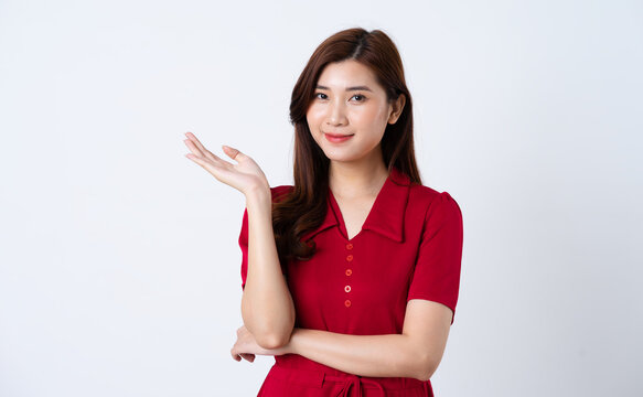 Portrait of a beautiful, charming lady wearing a red dress on a white background