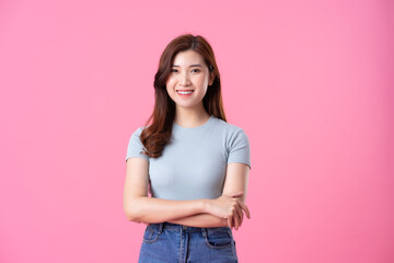 portrait of young asian girl posing on pink background