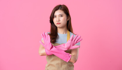 portrait of asian girl wearing apron on pink background