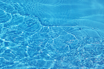 Blue water with ripples on the surface. Defocus blurred transparent blue colored clear calm water...