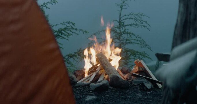 Campfire burning at a mountainside camp